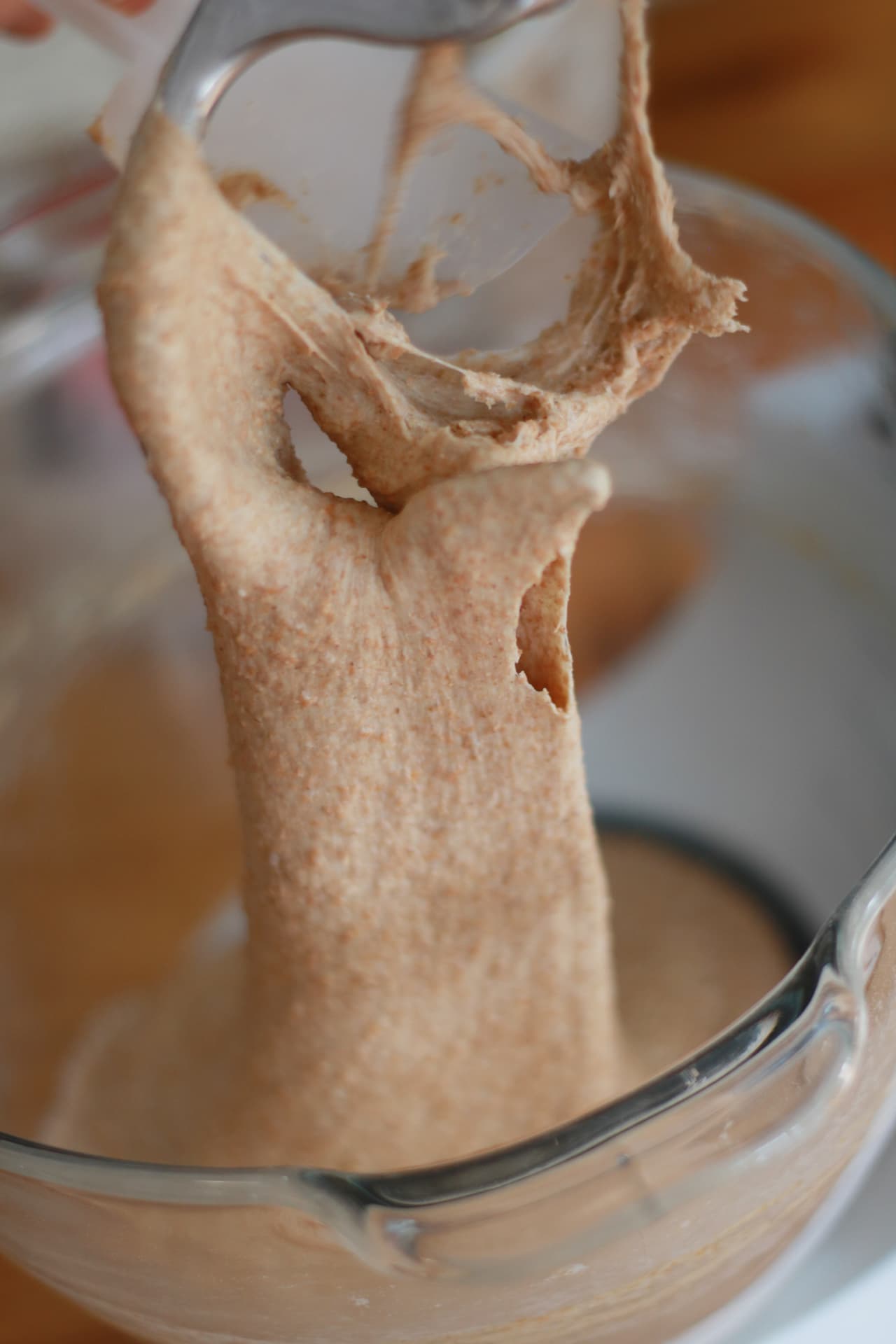 Whole wheat dough stretching from a mixer beater