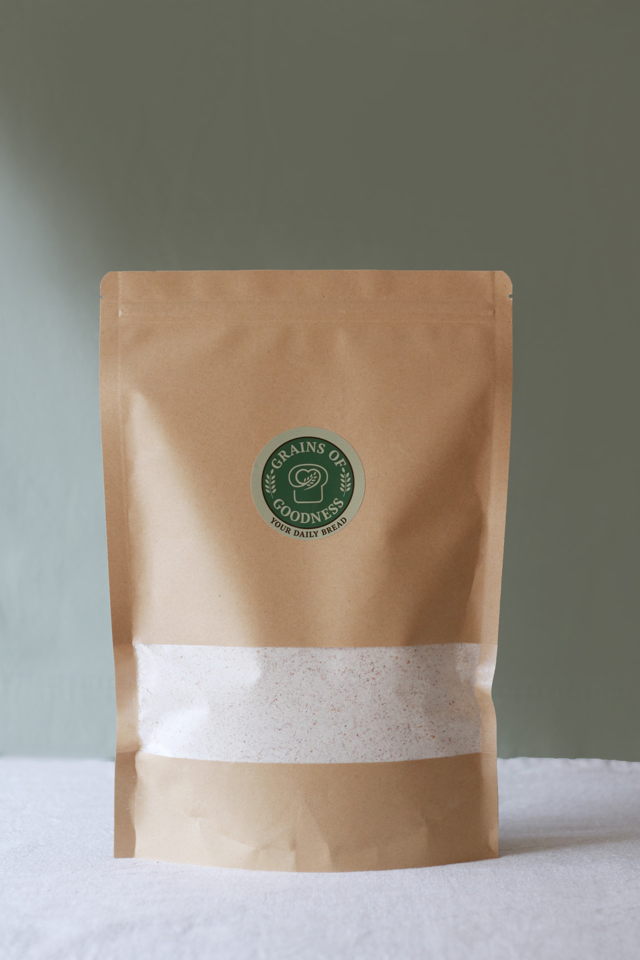 Grains of Goodness kraft bag filled with freshly milled whole wheat flour